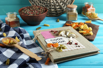 decorated cookbook on blue wooden background