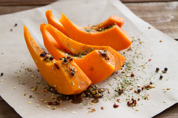 slices of pumpkin with spices on parchment paper