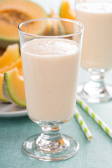 Healthy cantaloupe smoothie in a tall glass