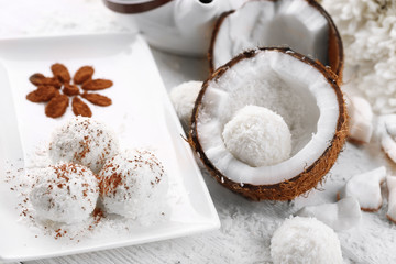 Homemade coco sweets on plate, on light background