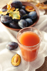 Plum Juice in a glass with fresh fruits