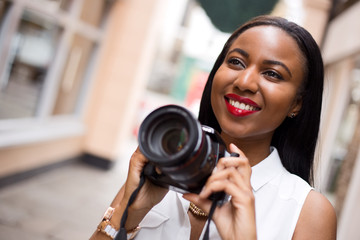 young woman holding a camera