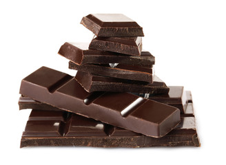 Black chocolate pieces isolated on white background