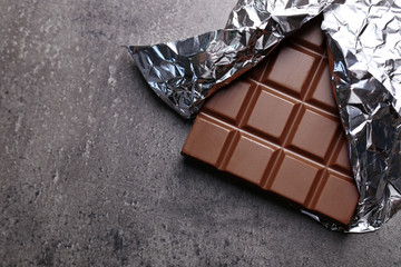 Chocolate bar in foil  on gray background