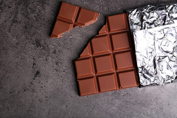 Chocolate bar in foil  on gray background