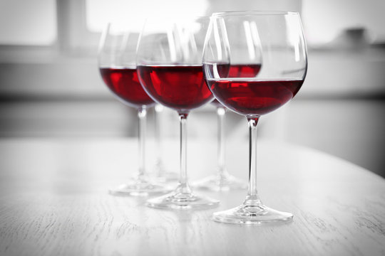 Wine glasses in restaurant on light background