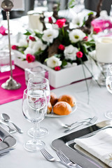 Wedding dinner table. Wineglasses,flowers and bread.