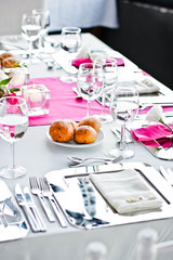 Wedding dinner table.Wineglasses,flowers and bread.
