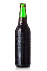 Bottle of beer with drops isolated on white