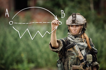 woman soldier writes marker on transparent glass