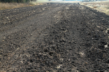 Autumn plowed strip of land. Preparing for winter in the village