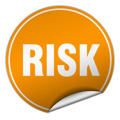 risk round orange sticker isolated on white