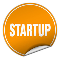 startup round orange sticker isolated on white