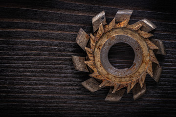 Rusty rotary cutter on vintage wooden background construction co