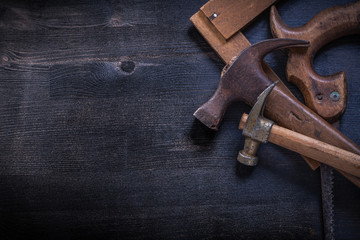 Vintage square ruler claw hammers hand saw construction concept