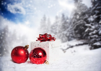 Christmas decorations and gift box in snow - snowy firs in the b