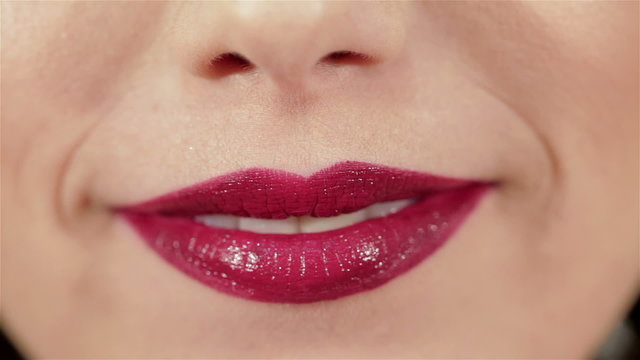 Girl blowing a kiss to her lips with red lipstick