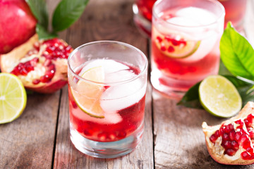 Pomegranate cocktail with lime slices