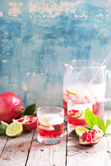 Pomegranate cocktail with lime slices