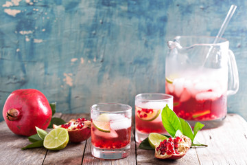 Pomegranate cocktail with lime slices