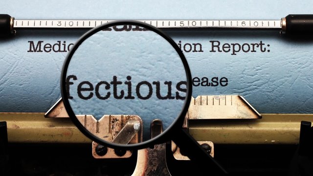 Magnifying glass on medical report infections