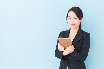 portrait of asian businesswoman on blue background