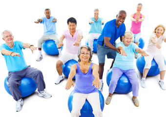 Group Of Multi-Ethnic Senior Adults Exercising Yoga Concept