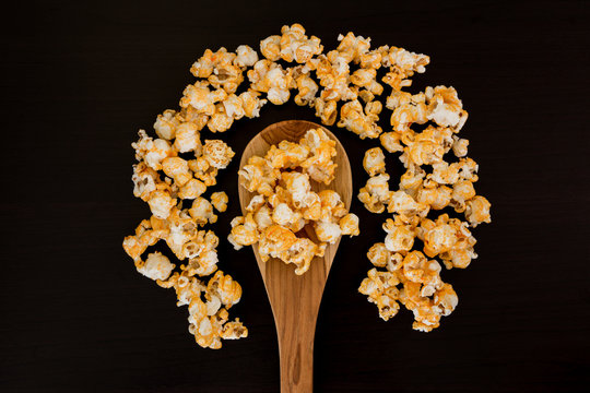 popcorn and ladle scoop on wooden table.