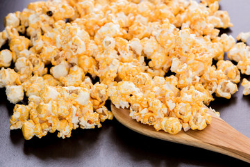 popcorn and ladle scoop on wooden table.