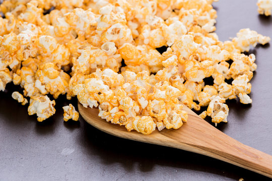 popcorn and ladle scoop on wooden table.