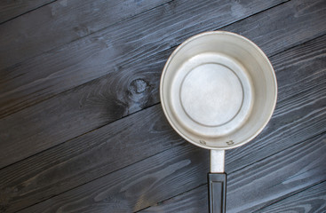 deep pot on wooden background in dark tone