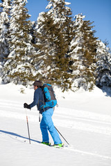 Fototapeta na wymiar Cross-country skier - snowy mountains in the background