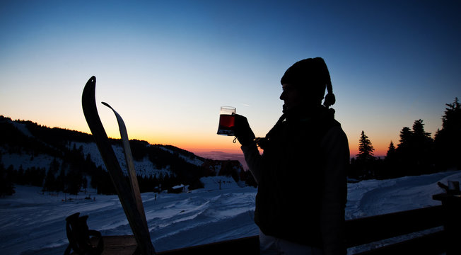 Apres Ski, Winter Holiday - Young Woman Drinking Wine At Sunset