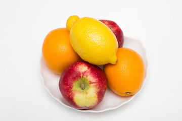 two orange and apple fruits with one lemon