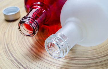 white and red glass bottle