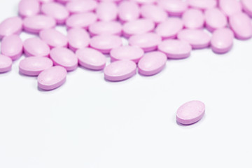 The pink tablets isolated on white background