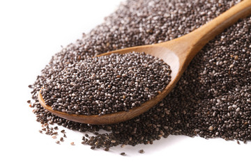 Chia seeds macro in a wooden spoon isolated on a white. Horizontal
