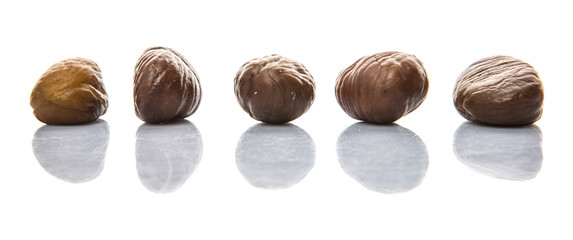 Roasted whole peeled chestnut over white background