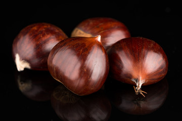 Chestnuts on a black reflective background