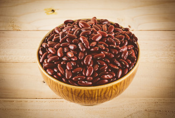 red  beans on wood background - soft focus with vintage film fil