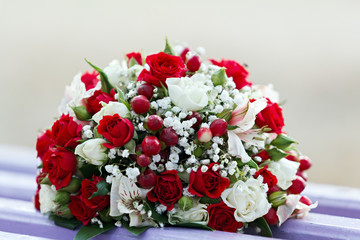 Wedding bridal bouquet lying on a park bench.