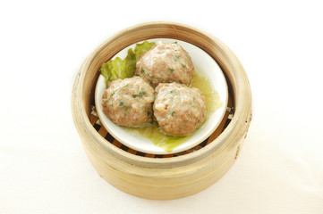 Steamed beef balls. yumcha. dim sum in bamboo steamer with chinese bun, pao, bao zi, steamed dumpling, shumai on table in chinese restaurant. chinese cuisine.
