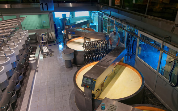 Modern cheese dairy factory in the historical town of Gruyeres, Switzerland. Swiss cheese factory production process.