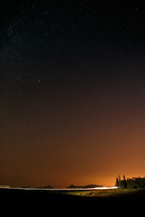 Highway on a background of bright stars of the night sky 