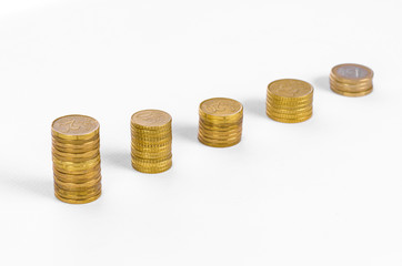 Money and business topic: Diagram of golden coins on a white background in studio