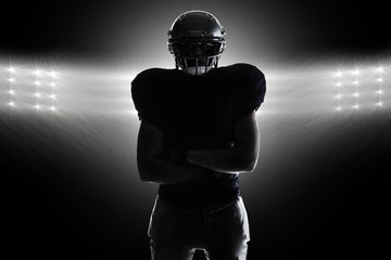 Composite image of silhouette american football player standing - Powered by Adobe
