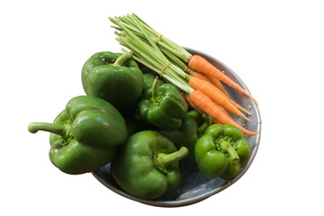 Green pepper and little orange carrot in pot
