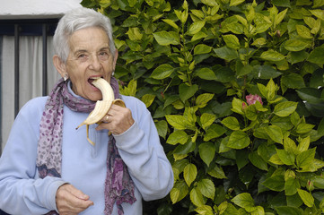 senior woman eating banana