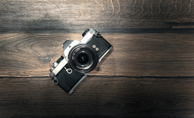 Old retro camera on vintage wooden planks, above view