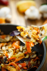 fried mushrooms with peppers and onions